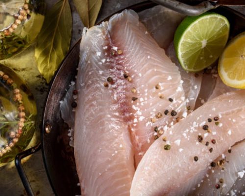raw tilapia fillet with ingredients